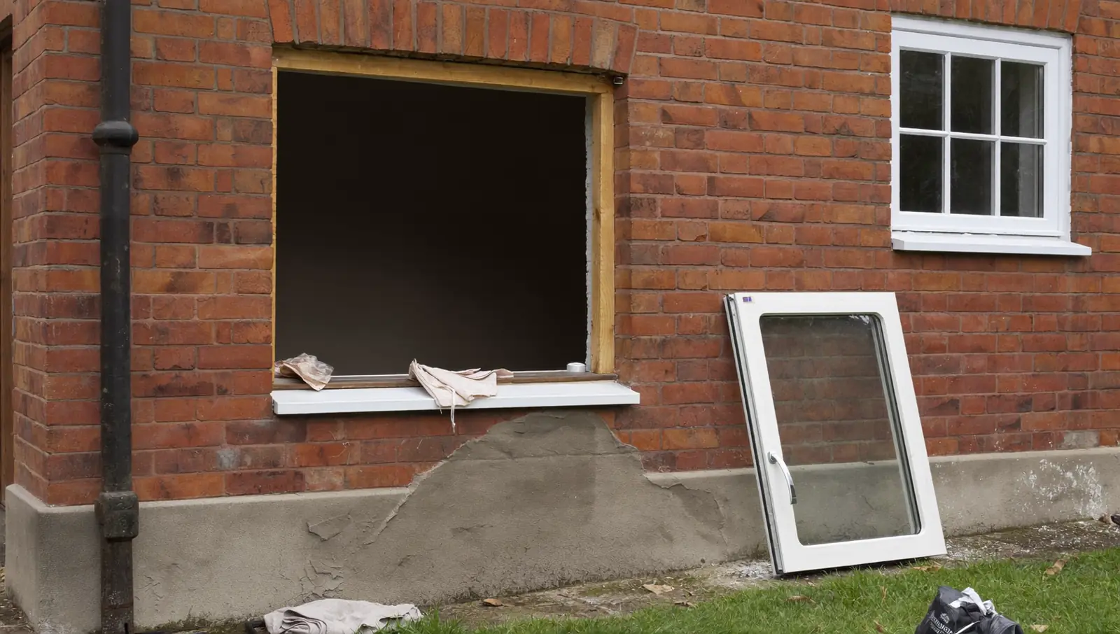 Old window removed from an opening during replacement, a new unit ready to fit
